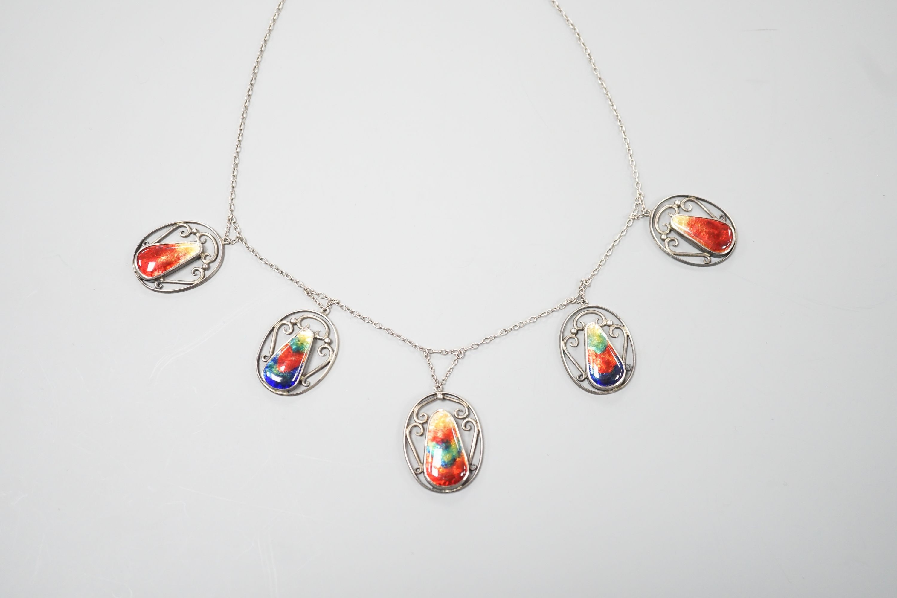 An Arts & Crafts white metal and six stone polychrome enamel set fringe necklace, 52cm.